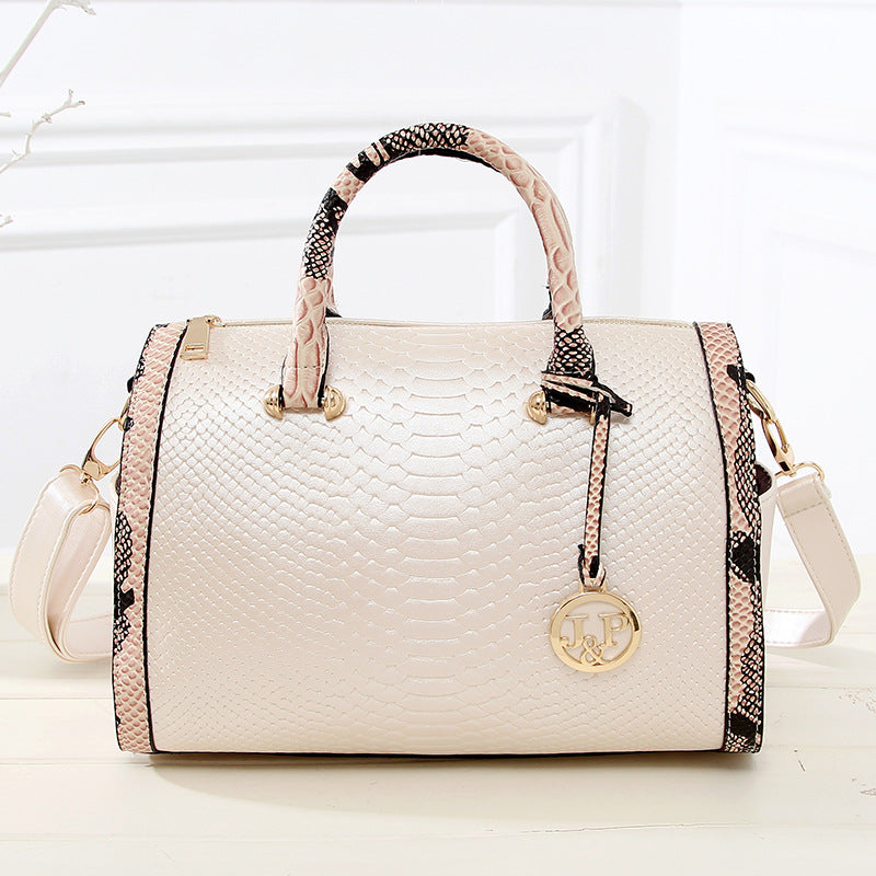 Luxe creamhandbag with snakeskin texture
